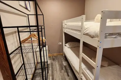 Image de This room is a bunk room with two single bunk beds. The bathroom and showers are shared with the two other bunk rooms. The room has a great view of the village square.