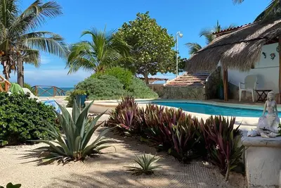Image de Charming single level beachfront home! Garden oasis & private waterfall pool.