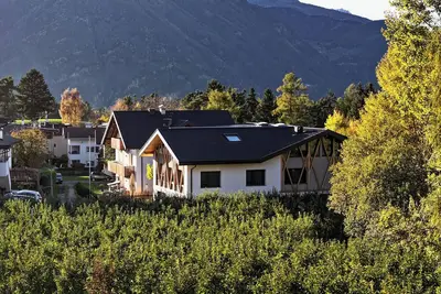 Image de Spacious Alpine-style apartment with private garden and pool view.