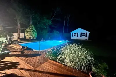 Image de 5-bedroom Cape with a pool and yard games.