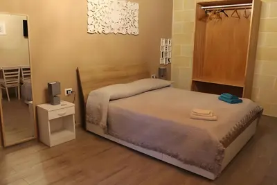 Image de Chambre d’hôtes « Le Carrube » avec Wi-Fi et climatisation