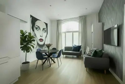 Image de Enjoy a spacious 100 m² apartment in the heart of Tilburg, perfect for up to 4 guests. Features a queen bedroom, comfy sofa bed in the salon, fully equipped kitchen with induction stove, oven, dishwasher, and Nespresso.