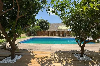 Image de A spectacular villa with 12 bedrooms in 6 separate units, a spacious living room, a fully equipped kitchen, a barbecue area and a heated pool. The villa also features a luxurious rooftop jacuzzi, a football table, ping pong,