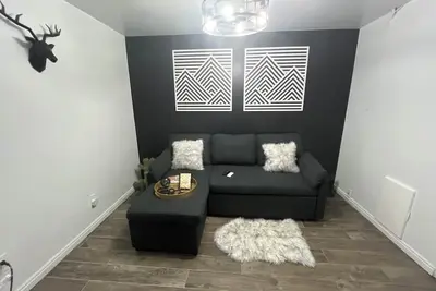 Image de Your Getaway Loaded with a Game Room is located in Basement of Twin Home.