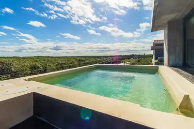 Image de Tranquil jungle retreat with soaking tub, chic decor, pool & patio dining