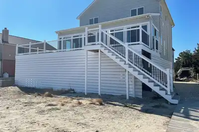 Image de \"Beach Haven\", beachfront house on Broadkill Beach, De with new deck and sunroom