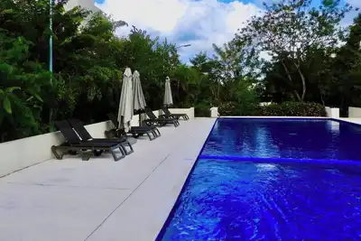 Image de Welcome to your modern Tulum retreat in Aldea Tulum Plus, a peaceful and closed community surrounded by jungle vibrations and designed for relaxation<br>This 2 bedroom condo on the ground floor (first floor) has a private patio and a pool