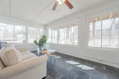 Image de Bright country retreat with sunny sunroom, cozy stove, and scenic pond and mountain views.