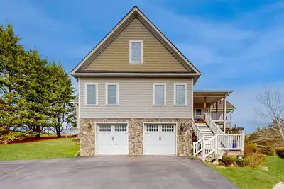 Image de Nature lover's lakefront home with a beach, dock, fire ring, & more