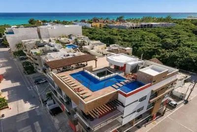 Serene vacation apartment with central Ac, strong WiFi, & a shared rooftop pool