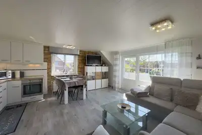 Image de Modern vacation apartment in Hooksiel with sunny balcony, two bedrooms, attic reading corner and quiet, central location near the North Sea.