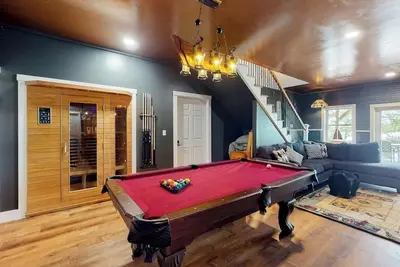 Image de Luxurious waterfront home with deck, firepit, hot tub, fireplace, & pool table