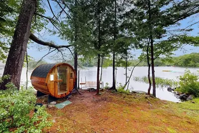 Image de Idyllic lakeside house with outdoor sauna, patio and firepit