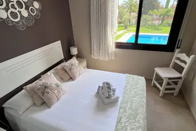 Image de Terrace, pool and garden Mont-Roig Bay apartment by the beach