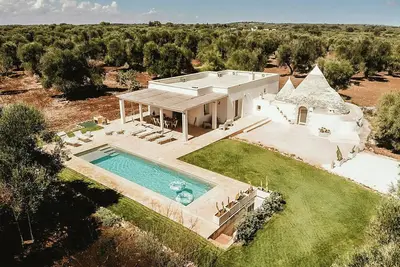 Image de Trullo parmi les oliviers centenaires dans la vallée d'Itria