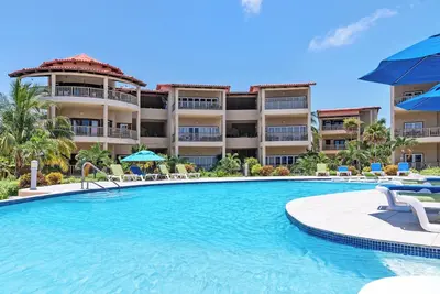 Spacious Condo w/ Balcony, Pools + Ocean Views