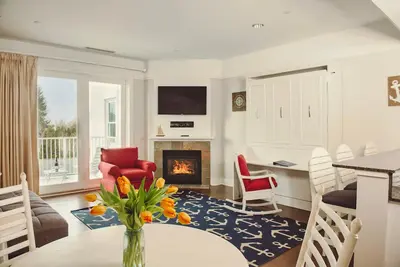 Image de Experience luxury at Captain Suite 219 in Bay Harbor, Mi, featuring a cozy bedroom and village view.