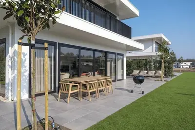 Image de Luxury 16-person villa by the water. Two spacious homes with hot tubs, saunas, and a private jetty. Perfect for families and groups of friends!