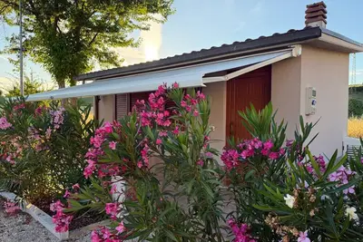 Image de A guesthouse with a fireplace in the garden of a villa with a pool; the beach is 5 minutes away