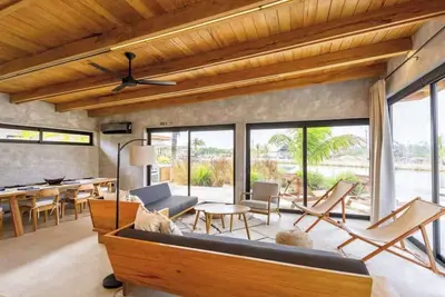 Image de Stylish waterfront villa with pool, lush views & floor-to-ceiling windows