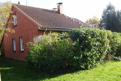 Image de proche de la plage, dans la verdure, adapté aux enfants, calme mais central, nouvelle cuisine, W-Lan, cheminée