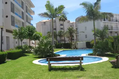 First line beach apartment with large terrace, communal pool and garage