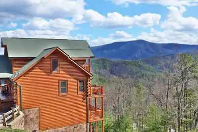 Image de Ce magnifique lodge avec une vue imprenable peut accueillir confortablement 18 personnes et propose quatre suites parentales.
