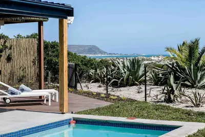 Image de Willow Beach House à droite sur les dunes de sable de Long Beach Noordhoek