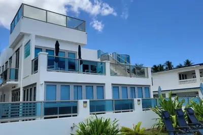 Une maison à couper le souffle en bord de mer avec 5 chambres et un toit