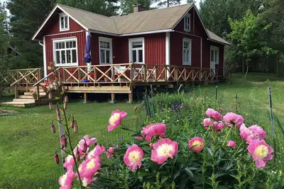 Image de Chalet traditionnel confortable pour 2 au bord de la mer! Sauna | bain à remous | quai de pêche | bateau