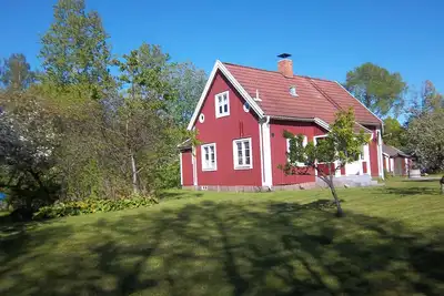 Image de Maison de vacances rouge marin près du lac et du golf avec bateau dans un village