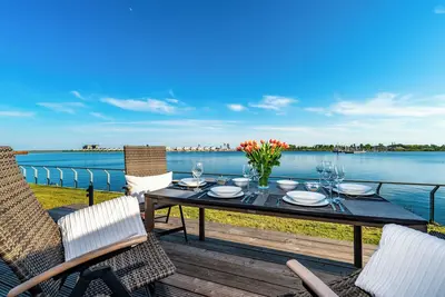 Image de Cet appartement de luxe est sur l'eau avec un sauna, une grande terrasse ensoleillée