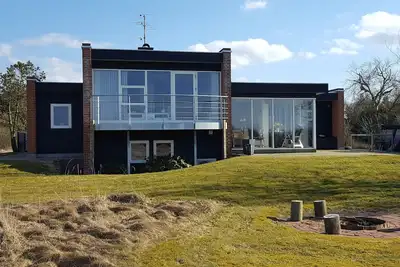 Image de Très belle maison d'été en 1ère ligne avec vue panoramique sur Dragstrup Vig. Wi-fi.