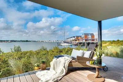 Image de Appartement de vacances de luxe onirique directement sur l'eau avec terrasse ensoleillée, sauna, cheminée