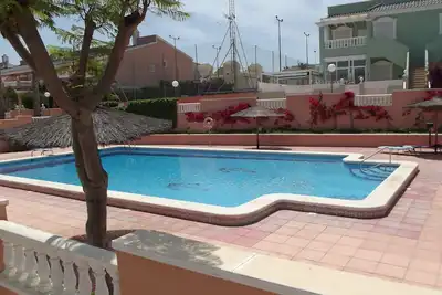Ground floor corner apartment with Wifi, spacious sunbathing area and pool views
