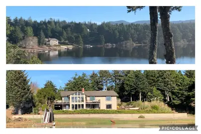 Image de Expansive Lake-Front Home avec quai pour bateau, bain à remous, table de billard. . .