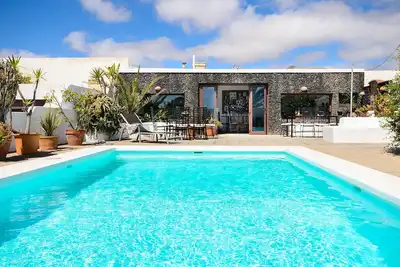 Image de Maison rustique à courte distance de la plage, avec piscine, terrasses et jardin