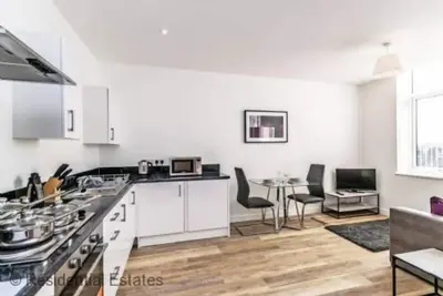 Image de Apt 21 City Suites - 1 lit - un chester pouvant accueillir 4 personnes dans 1 chambre