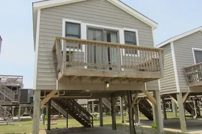 Image de Vous cherchez à amener vos chiens salés et à vous mouiller les orteils dans le sable?