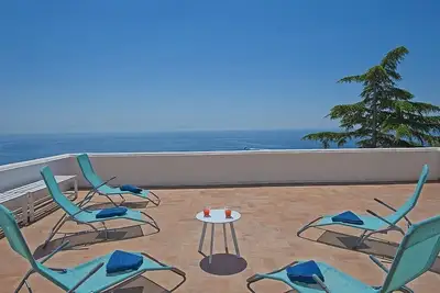 Image de Villa solaire: Une maison individuelle de deux étages caractéristique face au soleil et à la mer.