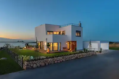 Image de Phare - 1 Emplacement, terrasse sur le toit, Schleiblick, abri de voiture, cheminée, sauna, terrasse, chaise de plage, volets roulants extérieurs, moustiquaires