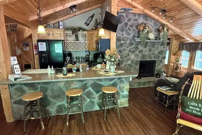 Image de Beautiful 2 Br cabin with a wall of windows overlooking the deck and stream.