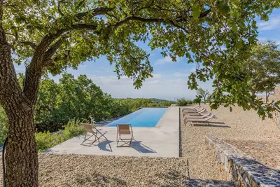 Image de Sciaraviva, maison sicilienne caractéristique entourée d'un vignoble biologique.