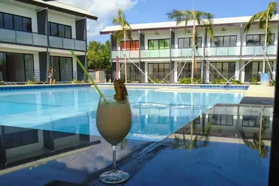New apartment with large pool and private roof terrace near the beach