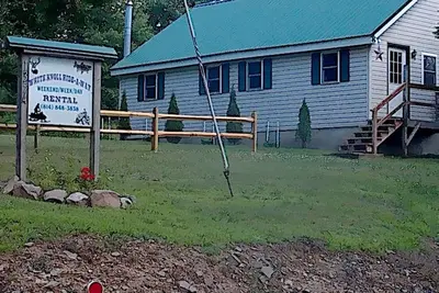 Image de White Knoll Hideaway, cabine chaleureuse et confortable au sommet de la montagne sur un chemin de terre calme