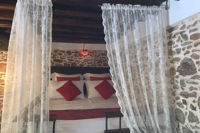 Image de Traditional stone built single room house with traditional bed.