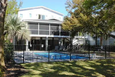 Second row home with private swimming pool, screened porch & deck located at North Litchfield Beach.