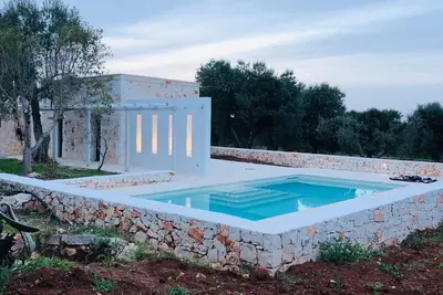 Image de White stone typical apulian villa  with barrel roof  surrounded by olive trees.