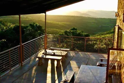 Image de Rustic stone walls with modern conveniences in an African setting.