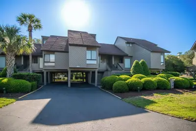 Villa with community pool access located within gated Litchfield By the Sea community.